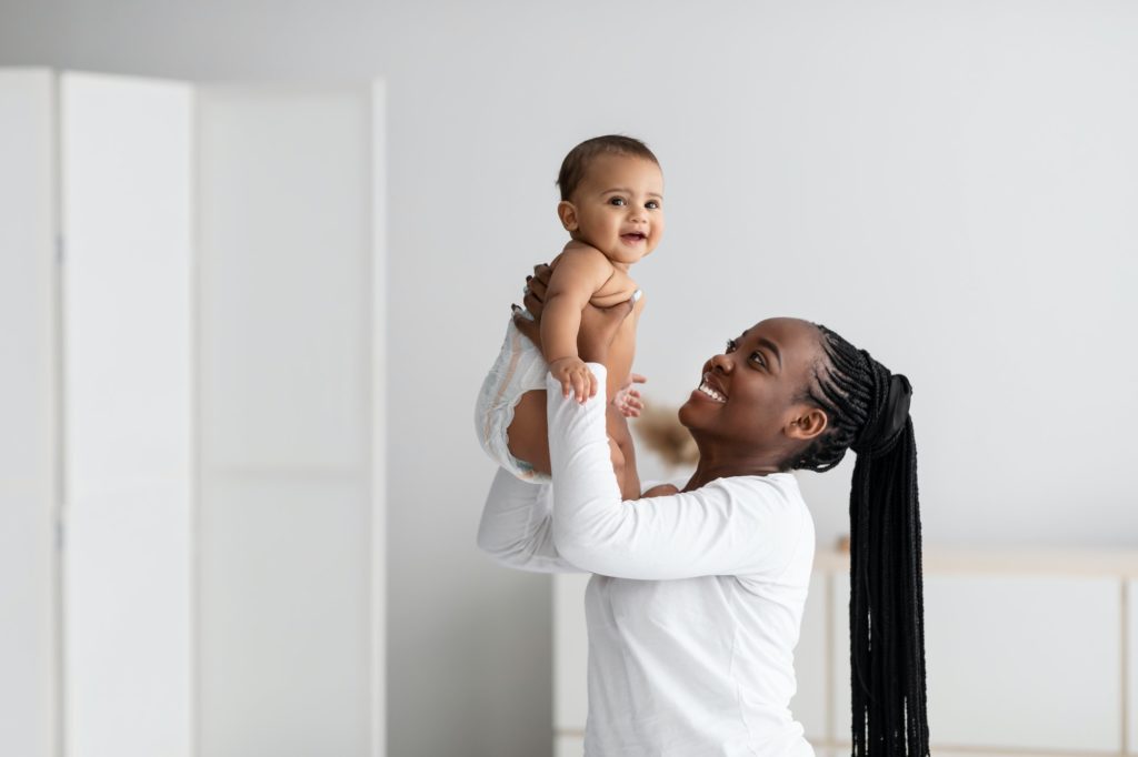 black woman playing with her cute little baby at home 1024x682 1